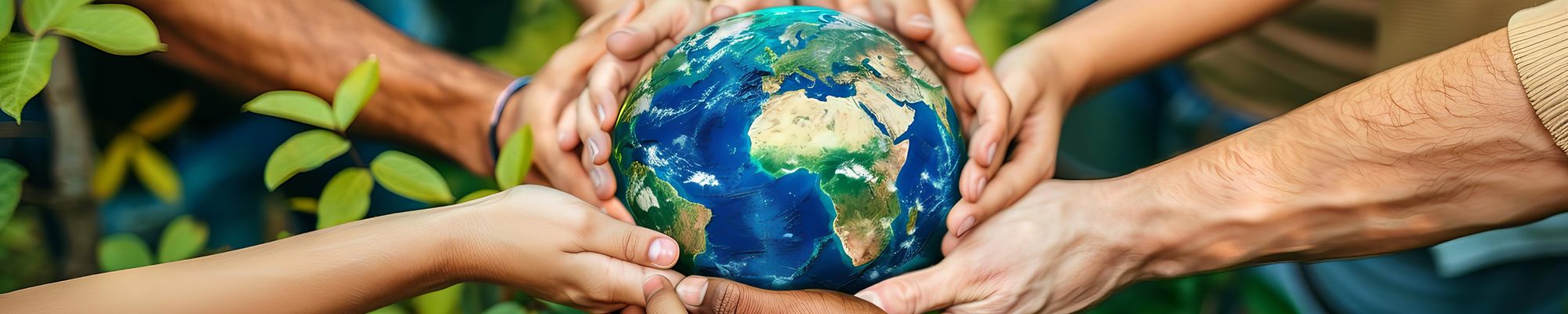 hands in greenery holding globe