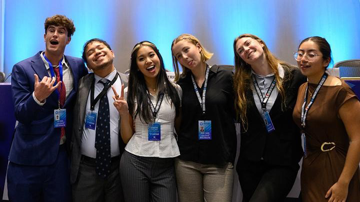 group of students pose at conference