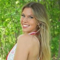 Sophia Hansen - smiling woman with long blonde hair looking back over shoulder